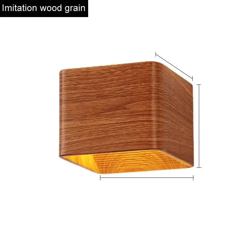 Modern wooden cube led wall light with warm brown wood grain exterior and amber glow ideal for bedroom decorbites led wall
