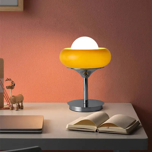 Modern yellow and chrome glass egg tart desk lamp with a spherical white bulb for bedroom lighting