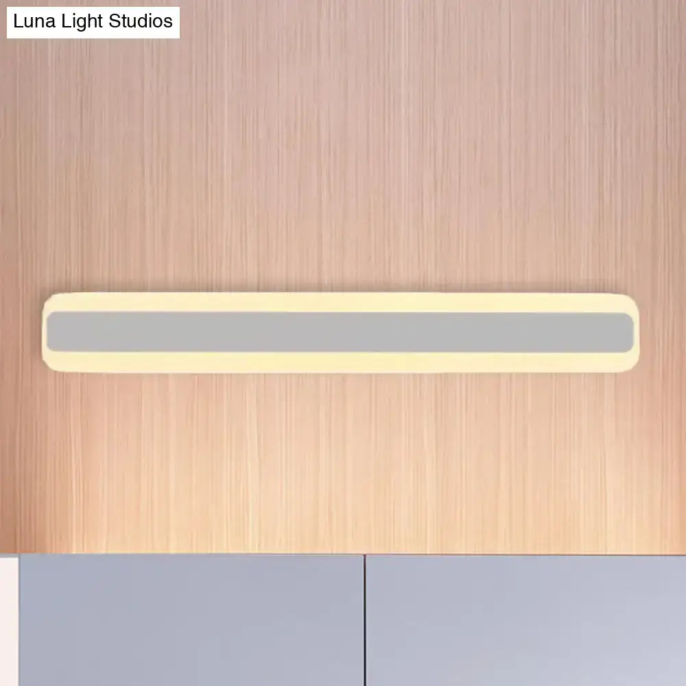 A sleek modern bathroom vanity led strip light with cream casing and gray illuminated panel providing white light