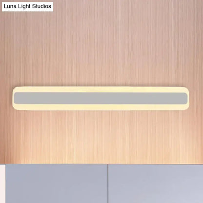 A sleek modern bathroom vanity led strip light with cream casing and gray illuminated panel providing white light
