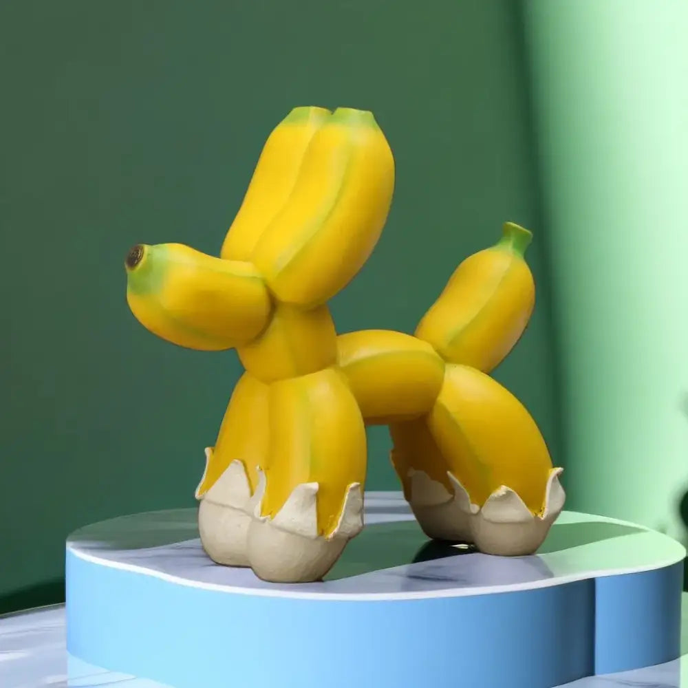 Modern yellow banana balloon dog sculpture with glossy finish and white eggshell base for living room pop art decor