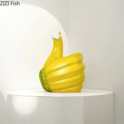 Modern yellow banana fist resin statue desk ornament shaped like an inflatable thumbs-up hand with green wristband and white heart
