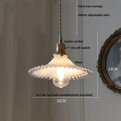 A vintage-style pendant light with frosted scalloped glass and decorbites copper knob iron socket for kitchens