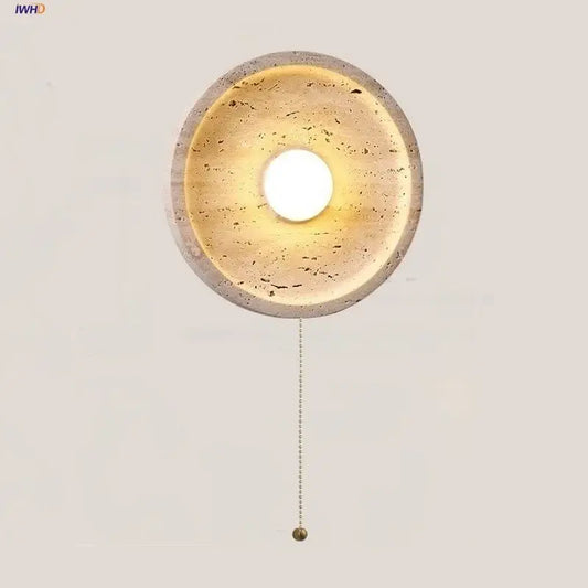Modern yellow stone led wall lamp with circular concrete design warm textured interior and brass pull chain for bedroom