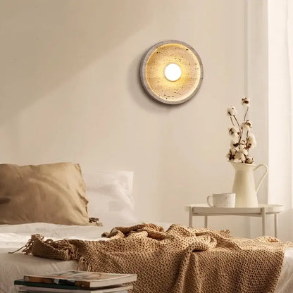 Modern yellow stone led wall lamp with textured speckled concrete finish and warm glowing center for bedroom lighting