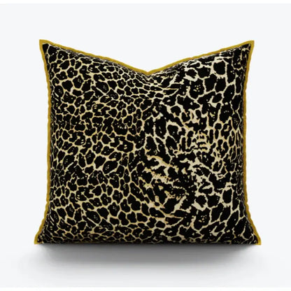 Square pillow cover with bold black and beige leopard print fabric and plush mustard-yellow velvet trim for decorbites gold zebra decor