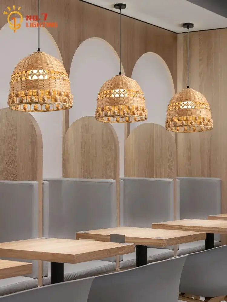 Three woven wicker bamboo weave pendant lights with golden beaded accents for modern zen dining room lighting