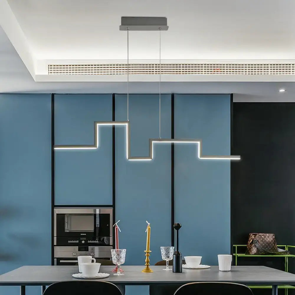 Modern geometric linear metal hanging light fixture with interconnected rectangular segments in matte gray for dining room
