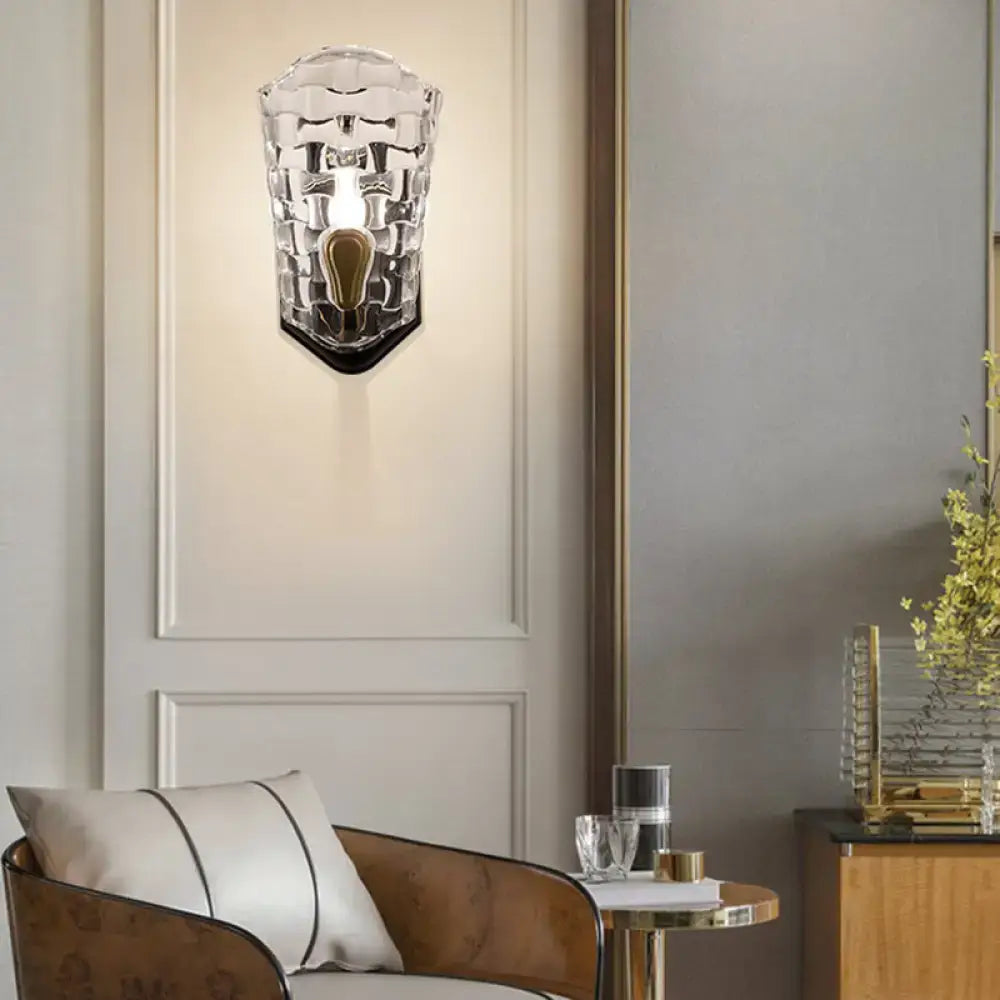 Modernist black and gold wall sconce featuring a clear crystal panel with textured glass and led incandescent fluorescent options