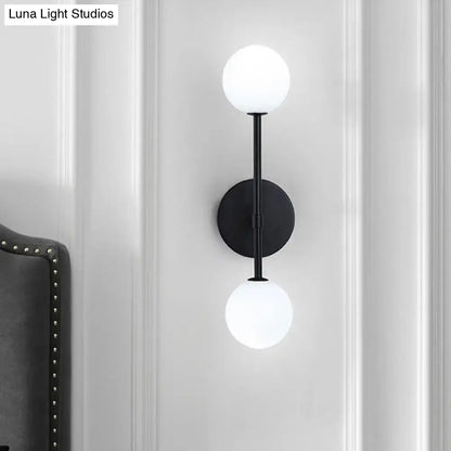 Modernist black gold metal wall sconce with double frosted glass globe shades for living room lighting