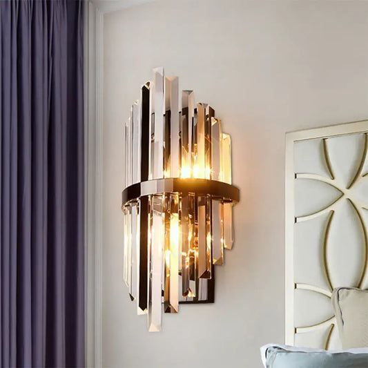 Modernist wall lamp with vertical clear crystal prism rods and polished brass frame for bedroom lighting