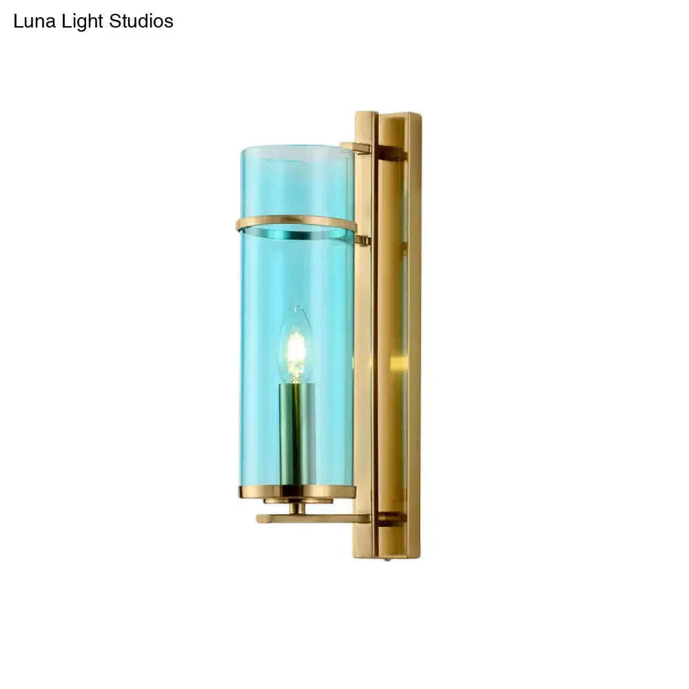 Modernist brass bedroom sconce light with water blue glass cylinder and warm bulb as elegant wall lamp fixture