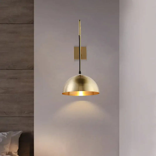 Modernist brass dome sconce wall light with a brass dome pendant light fixture and warm golden finish for bedroom use