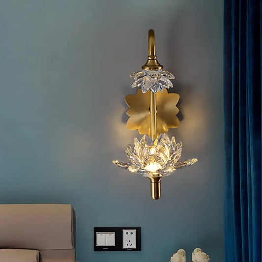 Modernist brass finish wall sconce with gold-toned crystal shade lotus flower design and central illuminated bloom