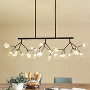 Black metal firefly hanging island chandelier with branching arms and clear modernist glass globe bulbs in black gold