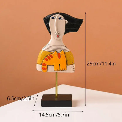 Stylized ceramic abstract people statue figure with black hair wearing yellow top holding orange cat for living room decorbites abstract people