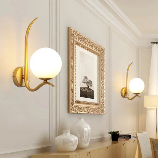 Modernist gold sconce light with a curved arm and white glass frosted globe shade for bedroom 220v-240v