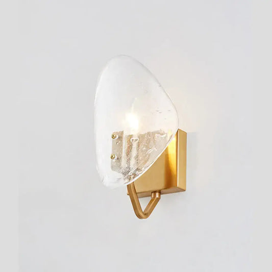 Modernist gold glass shield wall lamp with a translucent textured glass shade and brushed gold base for bedroom use with e12 e14 bulb