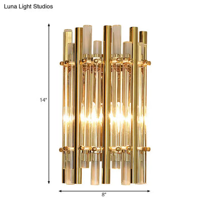 Gold-toned modernist tubular wall sconce with vertical glass tubes and frosted accents for bedroom lighting