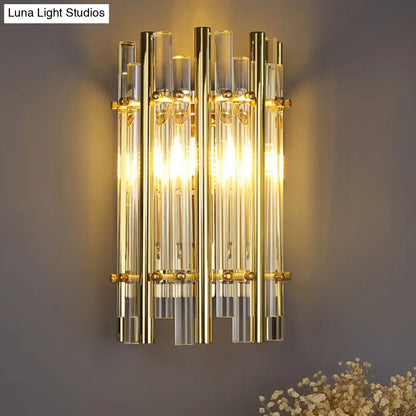Modernist gold tubular wall sconce with vertical glass tubes and brass accents for bedroom lighting