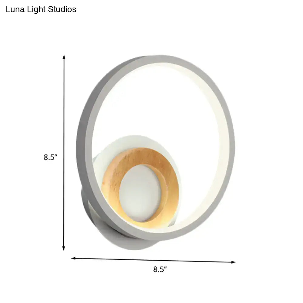 Modernist gray and wood ring wall sconce with a sleek gray outer ring and warm wood accent for bedroom lighting