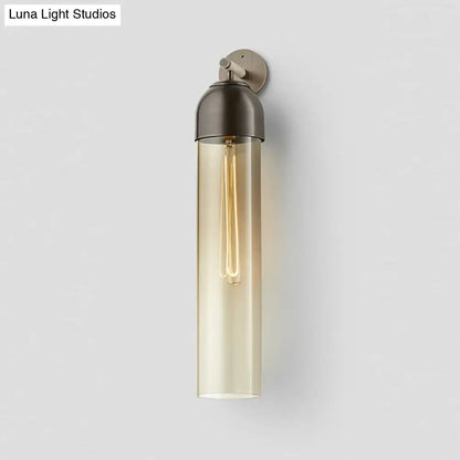 Modernist metallic tube sconce light with amber glass and brushed metal for bedroom featuring a curved arm