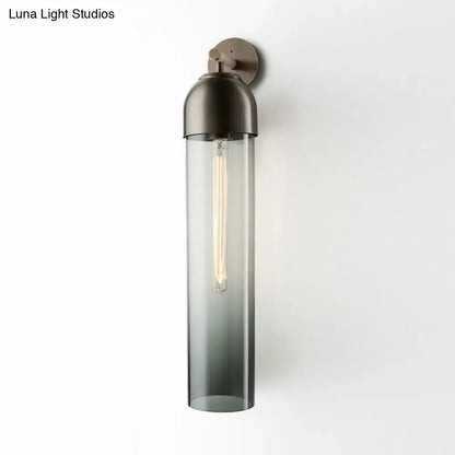 Modernist tube sconce light with dark bronze metal and amber glass cylinder for bedroom wall lighting
