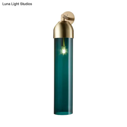 Modernist metallic tube sconce light with teal glass cylindrical shade and brass finish for bedroom use