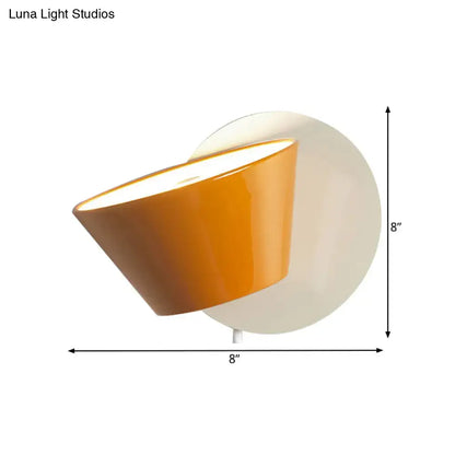 Modernist orange conical metal shade wall lamp with white circular backplate for bedroom lighting fixture
