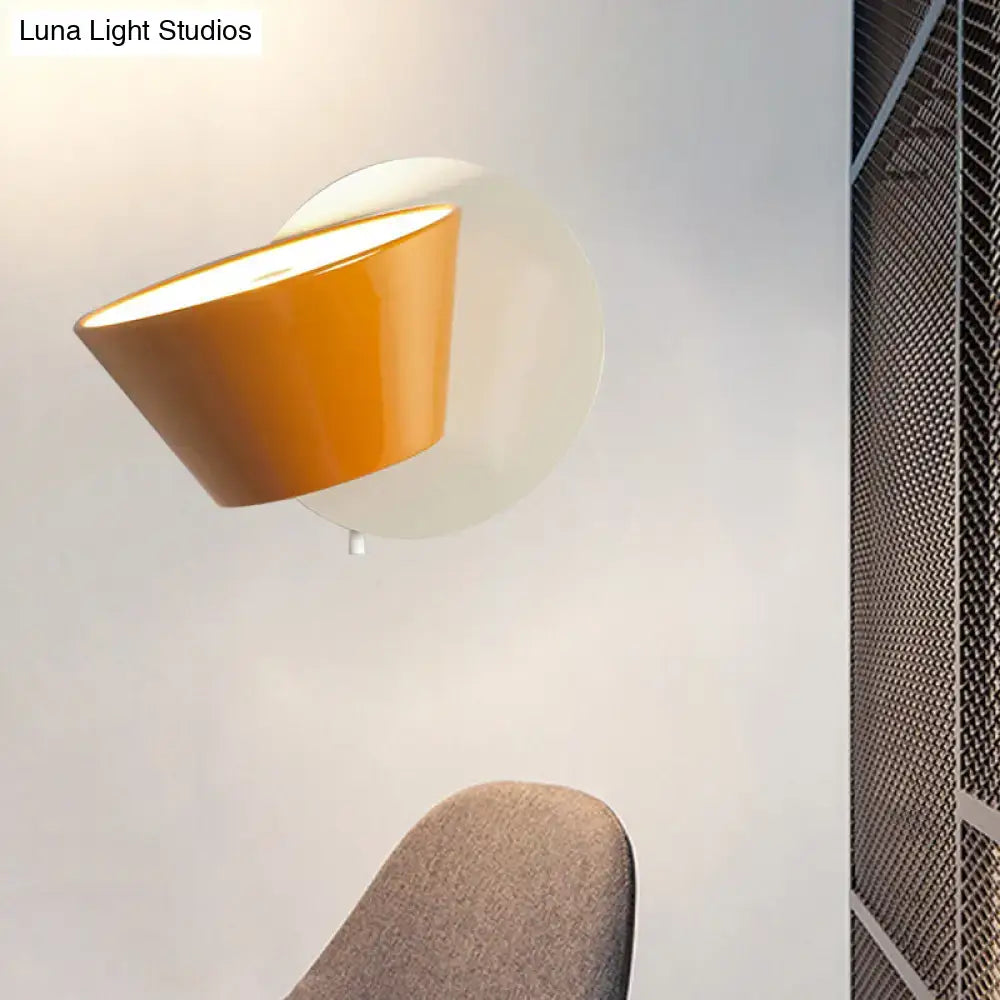 Modernist wall lamp with orange glossy metal shade and white circular base for bedroom lighting fixture