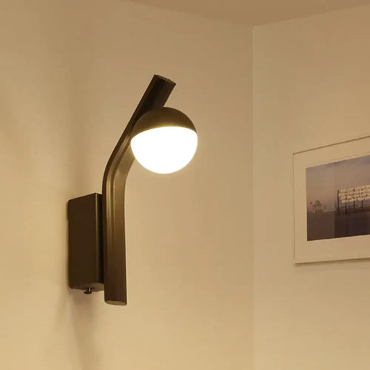 Modernist orb sconce wall lamp with black curved arm and frosted glass orb shade for stairway lighting