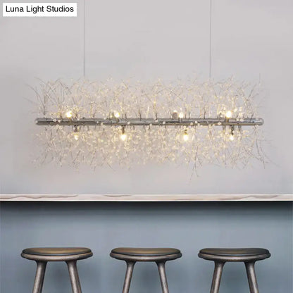 Decorbites modernist metallic branch island pendant light in silver with crystal bead deco strands emitting warm light