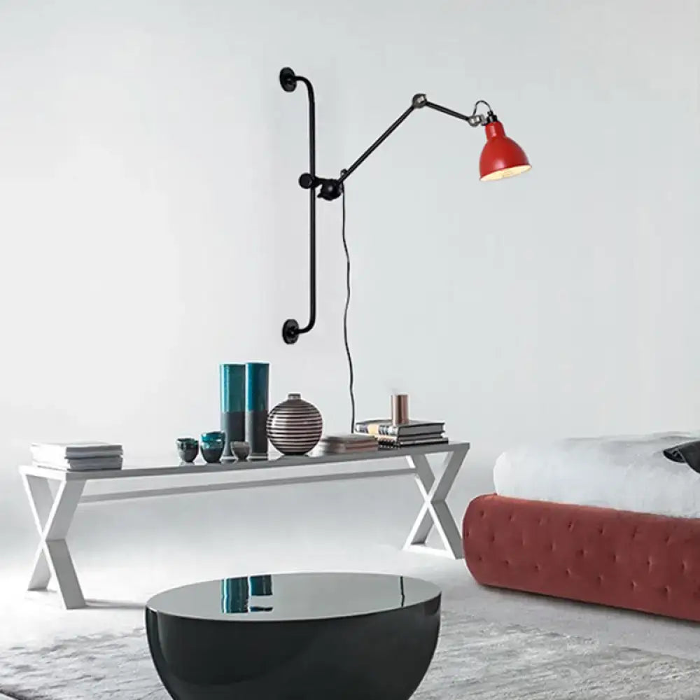 Red industrial-style wall light with black articulated arms and matte finish in modernist style black white dining room