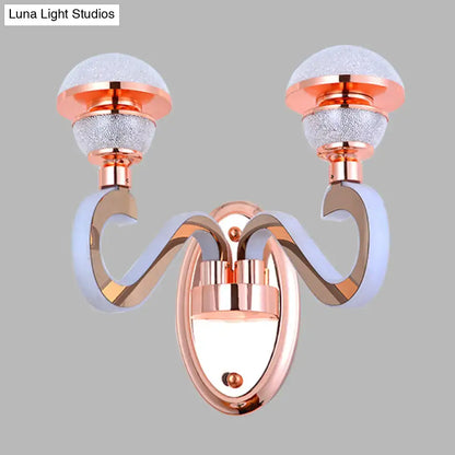 Modernist urn shape rose gold wall sconce with two curved arms and frosted glass globes for bedroom lighting