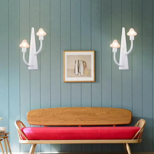 White ceramic wall sconces with curved arms and mushroom opal glass lampshades for living room lighting