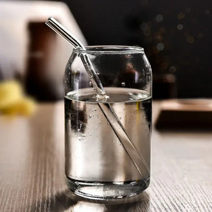 Clear glass motivational engraved shape beer glass cup with a sleek cylindrical design and a metallic straw inserted