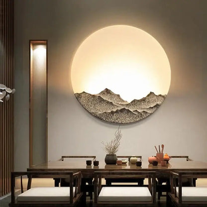 Circular decorbites led wall light with textured dark mountain design and warm glow for bedroom decor