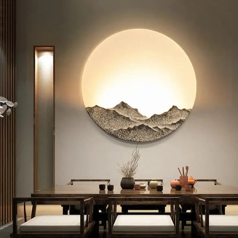 Circular decorbites led wall light with textured dark mountain design and warm glow for bedroom decor