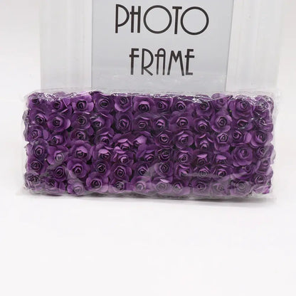 A package of decorbites 144pcs 2cm vibrant purple artificial paper roses neatly arranged in clear plastic for wedding decor