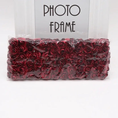A package of deep red decorbites 144pcs 2cm artificial paper roses in clear plastic wrap for wedding decor