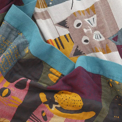Multicolor boho printed cotton blanket featuring stylized cartoon cats in teal mustard maroon and gray geometric pattern