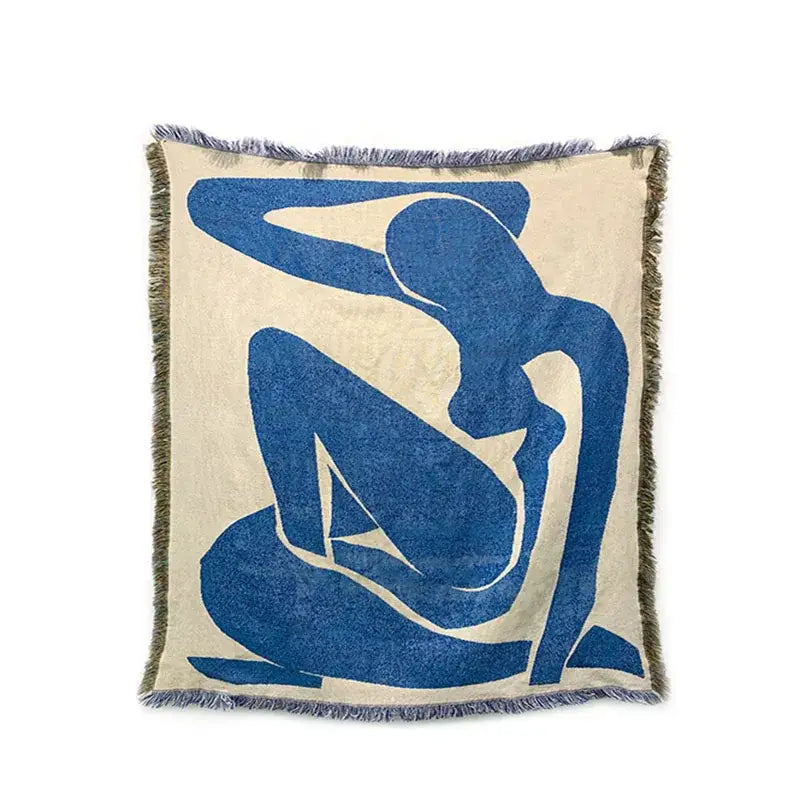 Beige jacquard tapestry blanket with bold blue abstract human figure design and fringed edges for living room throw