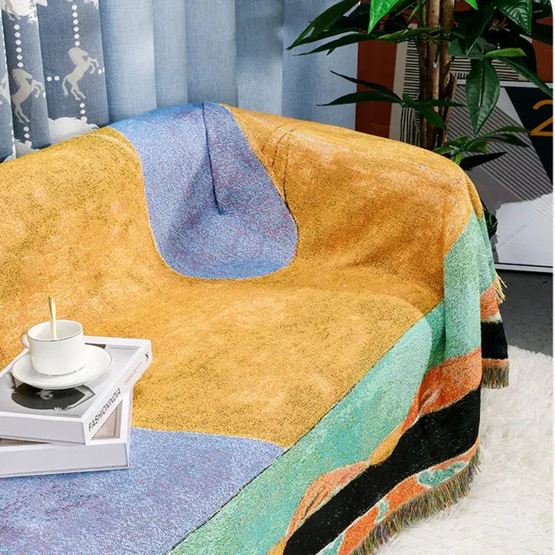 Multicolor patchwork striped jacquard tapestry blanket with textured weave and fringe in mustard yellow and blue tones