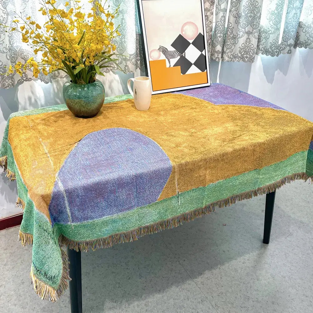 Multicolor jacquard tapestry blanket with geometric mustard yellow lavender and mint green pattern and fringed edges