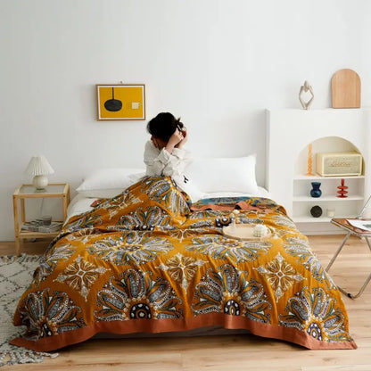 Vibrant mustard-yellow quilted cotton gauze boho throw blanket with floral and geometric patterns for decorbites decor