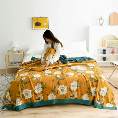 Warm orange floral decorbites cotton gauze boho throw blanket with white blossoms and teal border for living room