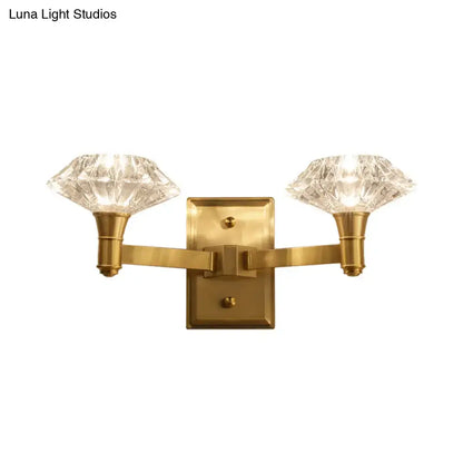 Mussel brass crystal wall mounted lamp with brass finish and two faceted crystal shades for bedroom wall lamp use