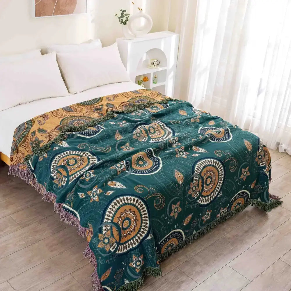 Cozy teal and gold cotton throw blanket with intricate circular decorbites gauze flowers and fringed edges for bedroom decor