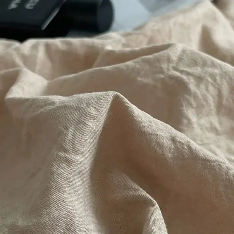Beige linen fabric with soft textured weave and folds in mustard textured cotton bedding set for decorbites cotton bedding