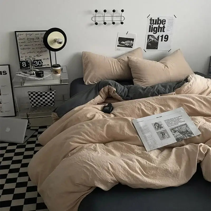 A cozy beige decorbites cotton bedding set with soft textured fabric draped over a dark gray bed frame